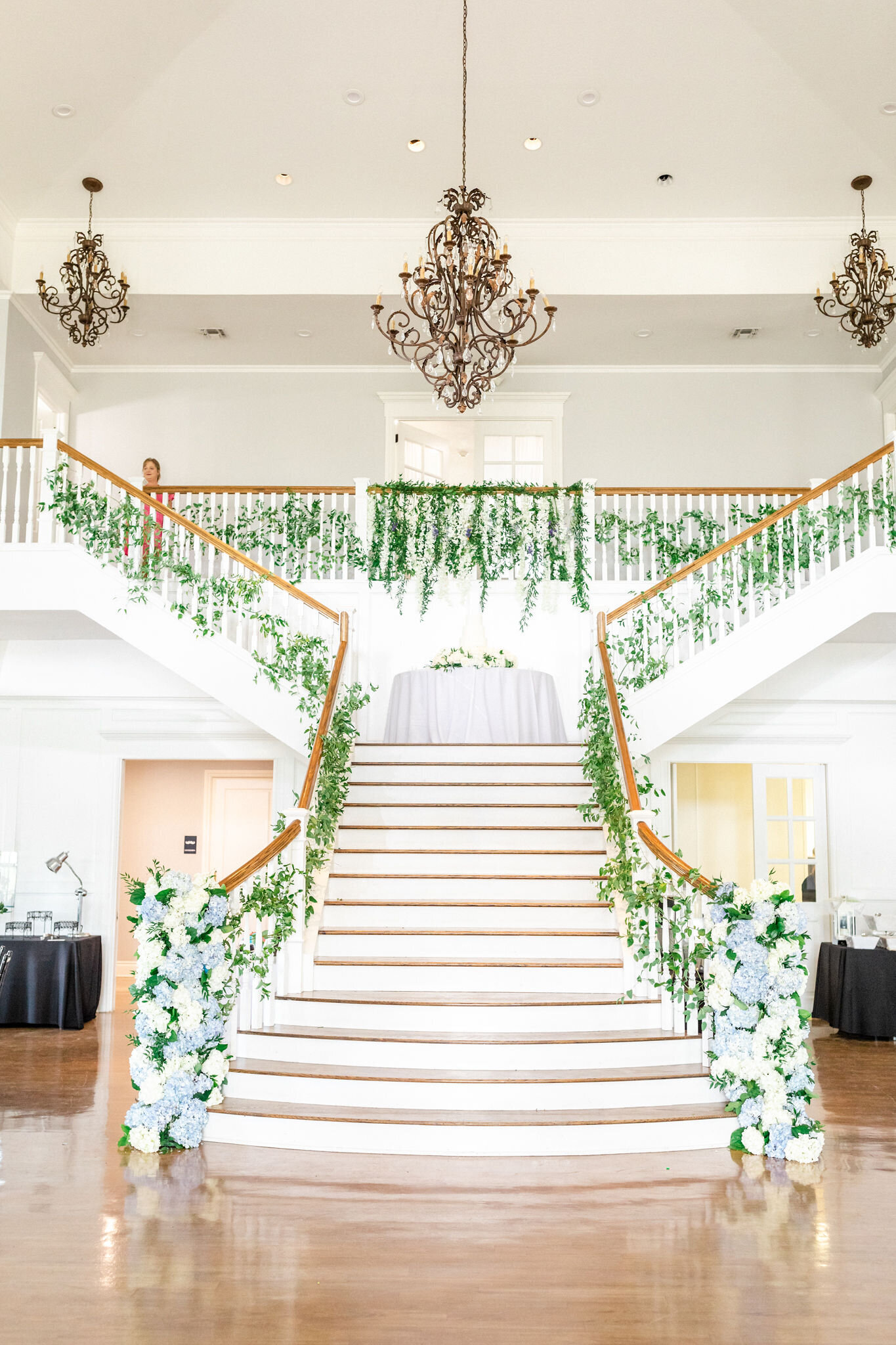 The Acre 31 grand staircase decorated with flowers.