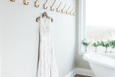 The wedding gown hanging in the bridal suite.