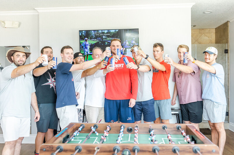 Groom and groomsmen cheers each other in the groom's suite.